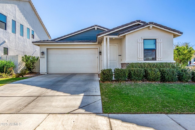 single story home featuring a garage, a tile roof, concrete driveway, stucco siding, and a front lawn