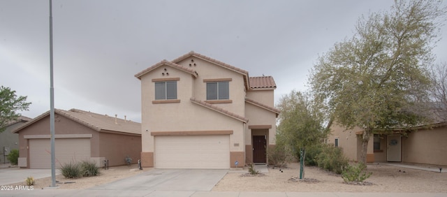 mediterranean / spanish-style home featuring a tiled roof, driveway, stucco siding, and a garage