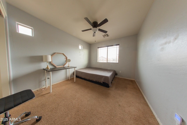 carpeted bedroom with visible vents, multiple windows, baseboards, and ceiling fan