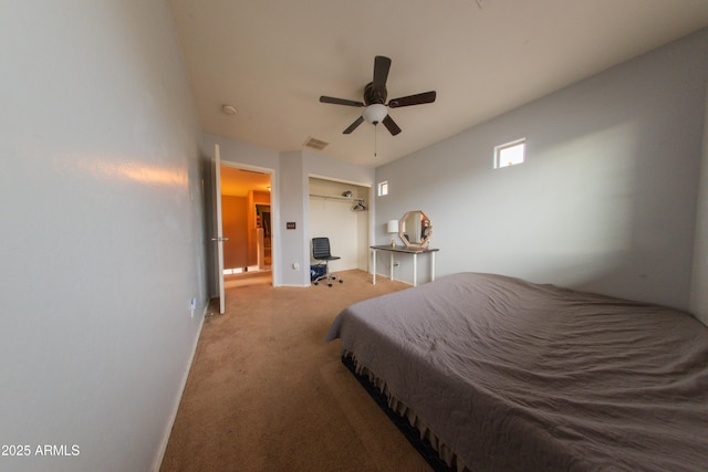 bedroom featuring a closet, a ceiling fan, visible vents, carpet flooring, and baseboards