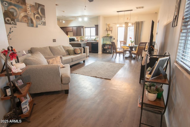 living room featuring plenty of natural light, visible vents, and wood finished floors