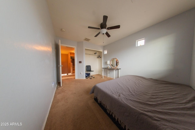 carpeted bedroom with visible vents, a closet, and ceiling fan