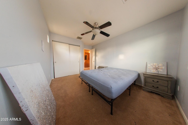 carpeted bedroom featuring baseboards, visible vents, a closet, and a ceiling fan