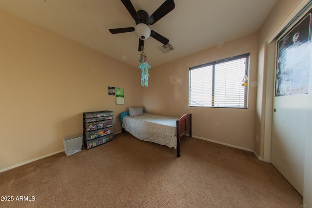 bedroom with visible vents, baseboards, ceiling fan, and carpet