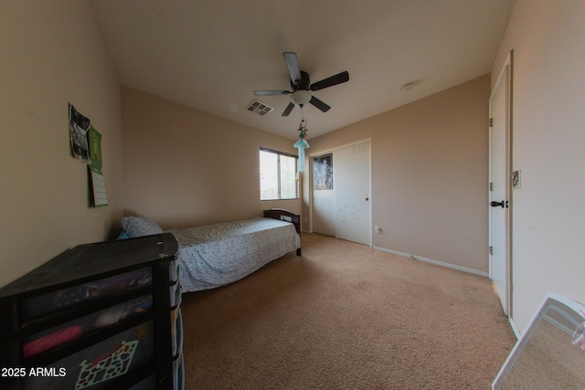 bedroom featuring visible vents, light colored carpet, baseboards, and a ceiling fan