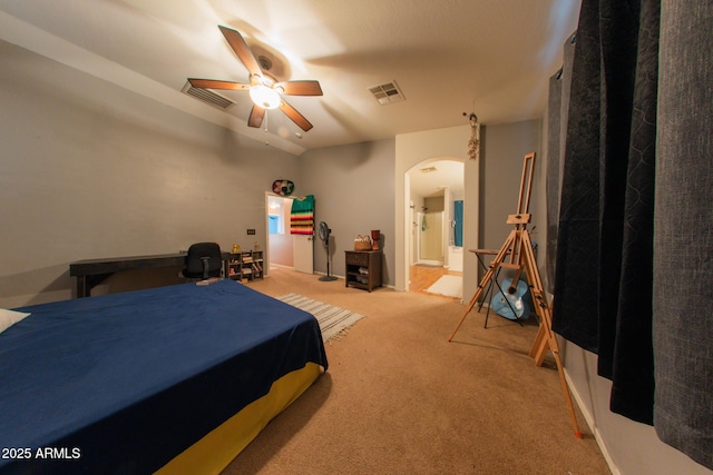 bedroom featuring visible vents, arched walkways, carpet flooring, and connected bathroom