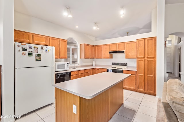 kitchen featuring light tile patterned floors, sink, white appliances, and a kitchen island