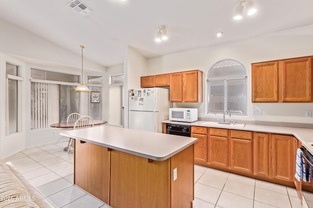 kitchen featuring white appliances, vaulted ceiling, sink, hanging light fixtures, and light tile patterned flooring