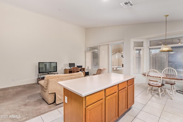 kitchen featuring pendant lighting, light tile patterned floors, lofted ceiling, and a kitchen island