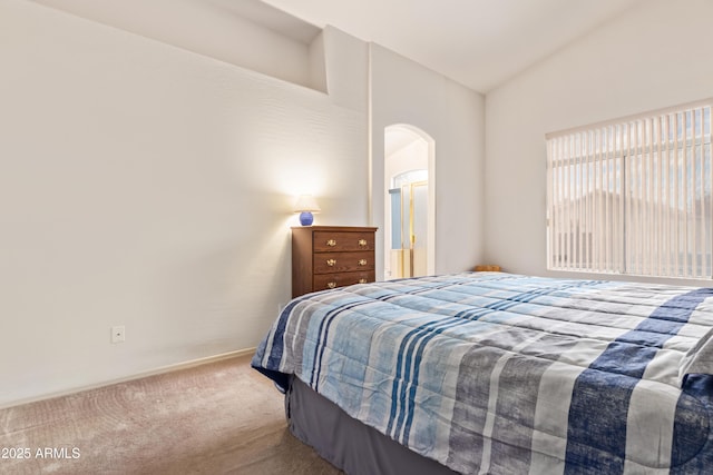 carpeted bedroom with vaulted ceiling