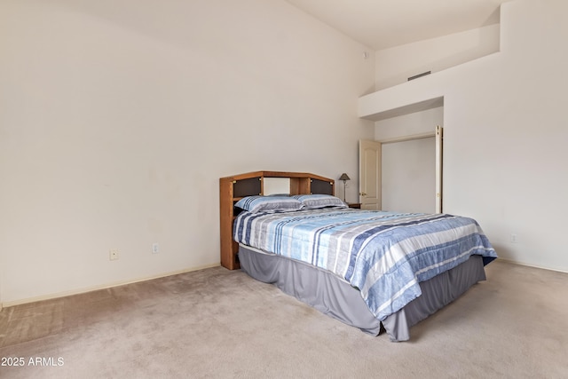 bedroom featuring carpet and high vaulted ceiling