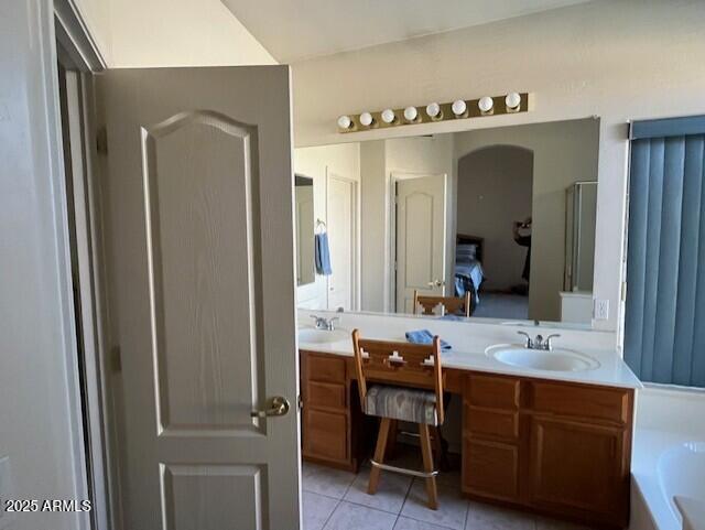 bathroom featuring tile patterned floors, vanity, and shower with separate bathtub