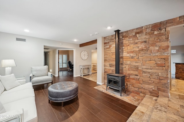 living room with dark hardwood / wood-style flooring and a wood stove