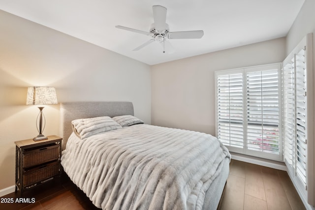 bedroom featuring ceiling fan and dark hardwood / wood-style floors