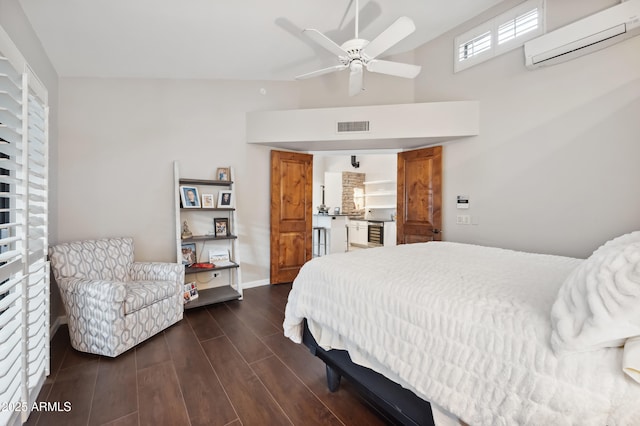 bedroom with ceiling fan, dark hardwood / wood-style floors, and a wall mounted AC