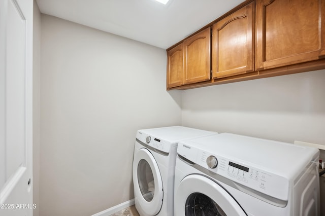 washroom with independent washer and dryer and cabinets