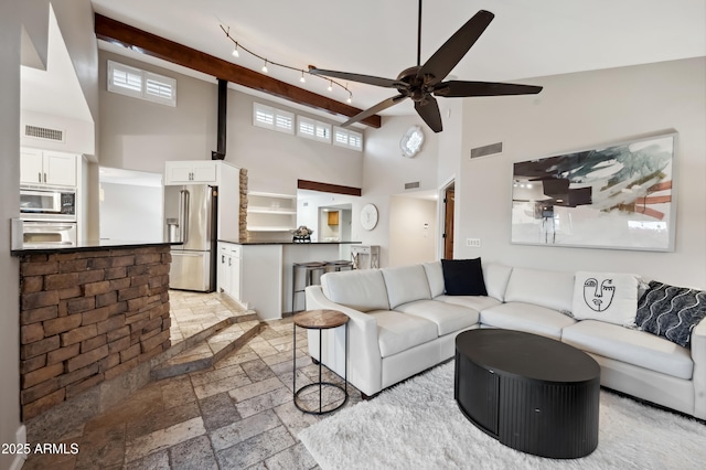 living room with high vaulted ceiling and ceiling fan