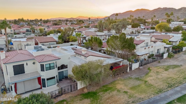 aerial view at dusk featuring a mountain view