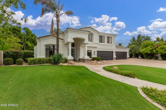 mediterranean / spanish-style house with an attached garage, a tiled roof, driveway, stucco siding, and a front lawn