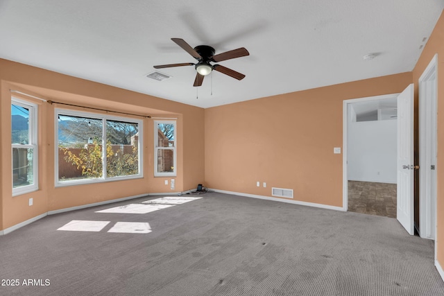 empty room featuring light colored carpet and ceiling fan