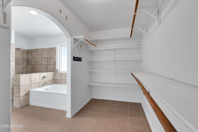 spacious closet featuring light tile patterned floors