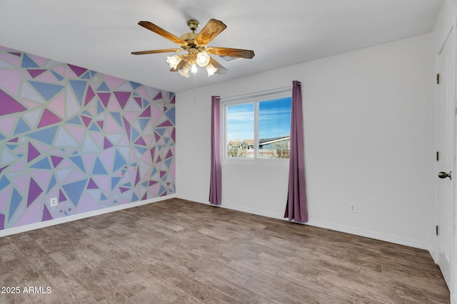 spare room with wood-type flooring and ceiling fan