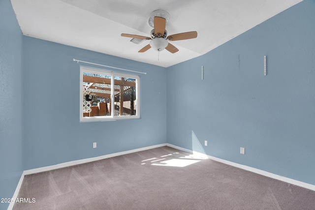 carpeted spare room featuring ceiling fan