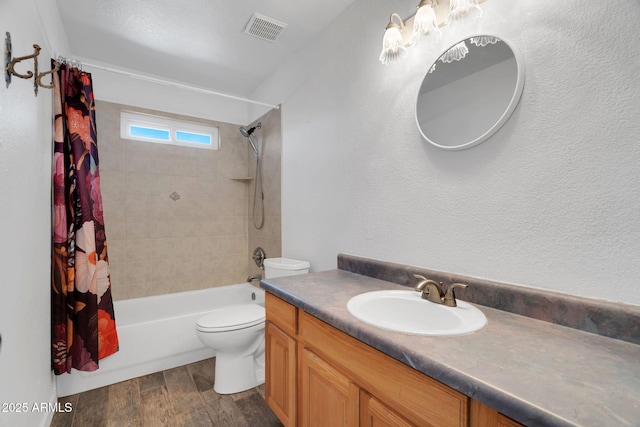 full bathroom with shower / tub combo, vanity, wood-type flooring, and toilet