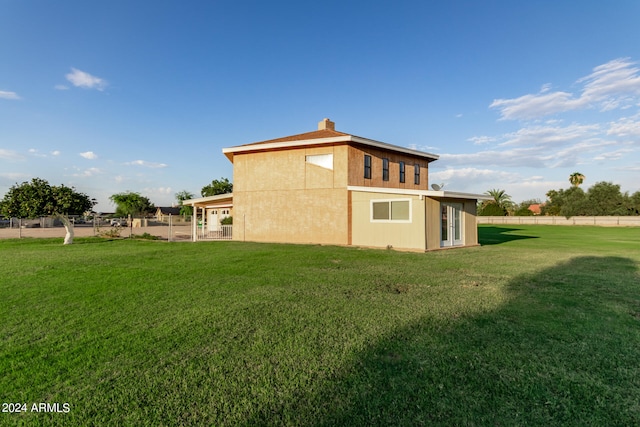 back of property featuring a lawn