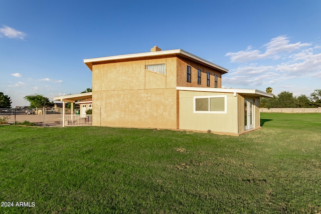 back of property featuring a yard