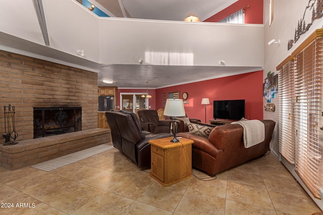 living room featuring a fireplace, crown molding, and a high ceiling