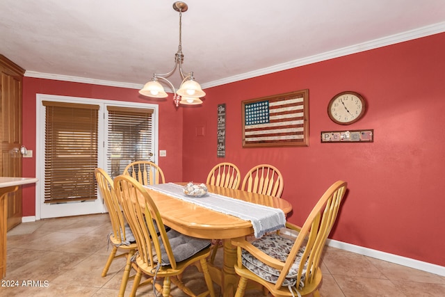 tiled dining space with ornamental molding and a chandelier