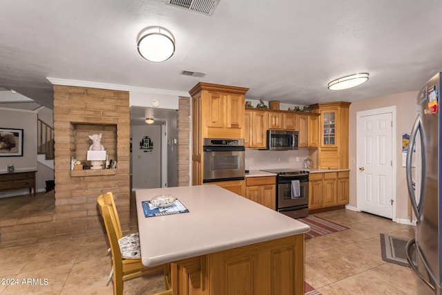 kitchen with stainless steel appliances, crown molding, and light tile patterned floors