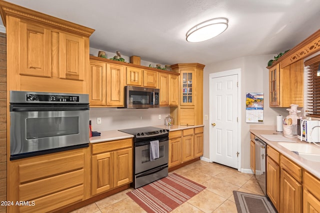 kitchen with appliances with stainless steel finishes and light tile patterned floors