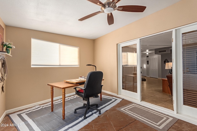 office area featuring dark tile patterned flooring and ceiling fan