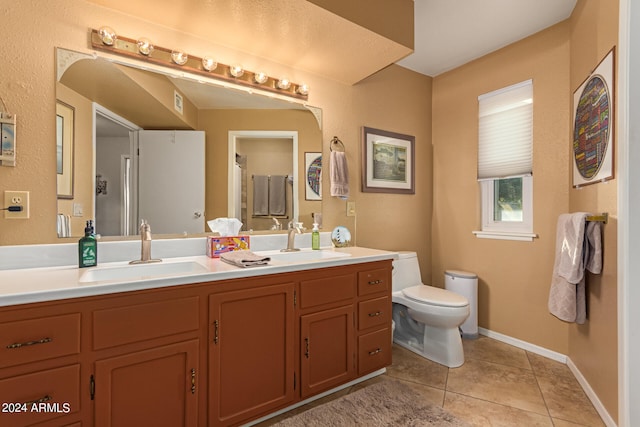 bathroom with tile patterned floors, vanity, and toilet