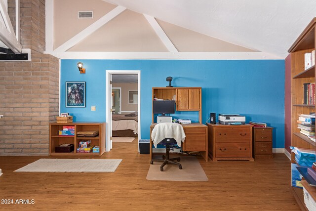 home office featuring light hardwood / wood-style floors and high vaulted ceiling