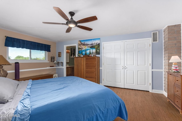 bedroom featuring hardwood / wood-style flooring, ceiling fan, a closet, and connected bathroom