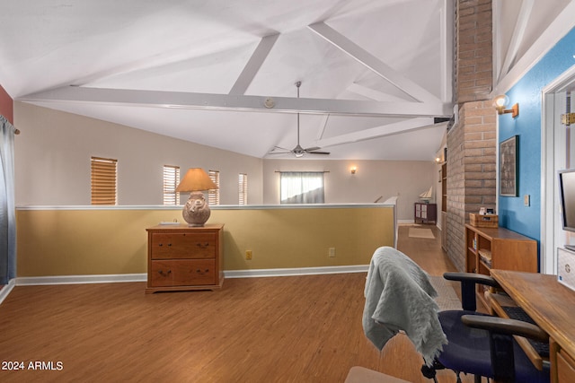 office space featuring ceiling fan, vaulted ceiling with beams, and wood-type flooring