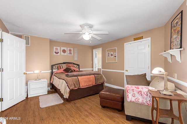 bedroom with ceiling fan and hardwood / wood-style flooring