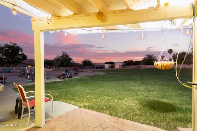 yard at dusk with a playground and a patio