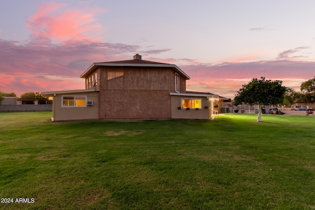 back house at dusk with a yard