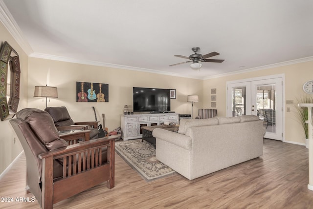 living room featuring crown molding, light hardwood / wood-style flooring, ceiling fan, and french doors