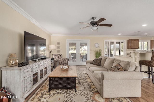 living room featuring french doors, plenty of natural light, and light hardwood / wood-style flooring