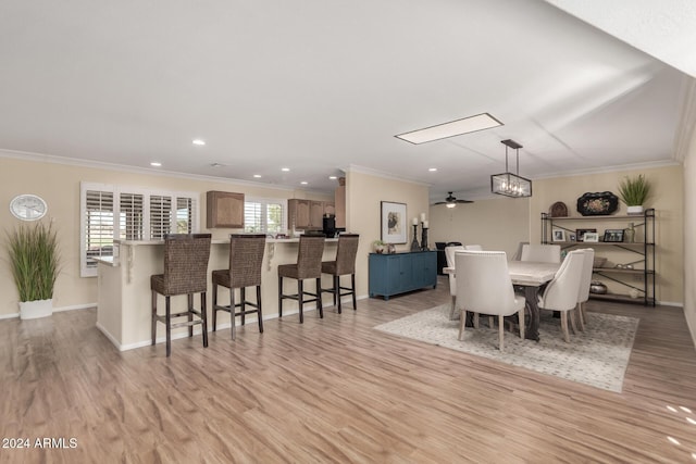 dining area featuring light hardwood / wood-style flooring, plenty of natural light, ornamental molding, and ceiling fan