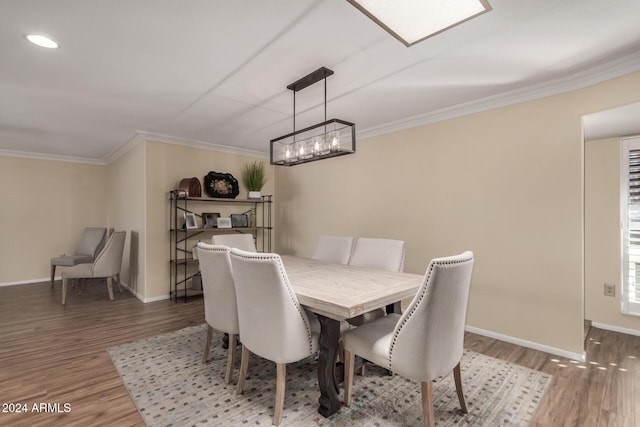 dining space featuring hardwood / wood-style flooring and ornamental molding