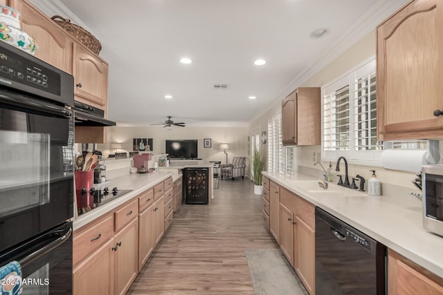 kitchen featuring black appliances, crown molding, sink, light brown cabinetry, and light hardwood / wood-style floors