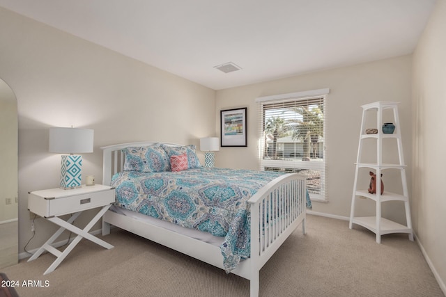 bedroom featuring light colored carpet