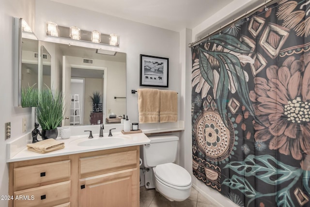 bathroom with tile patterned flooring, vanity, and toilet