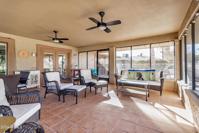 sunroom / solarium featuring ceiling fan and french doors